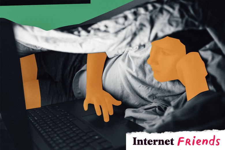 Boy looking at laptop under covers.